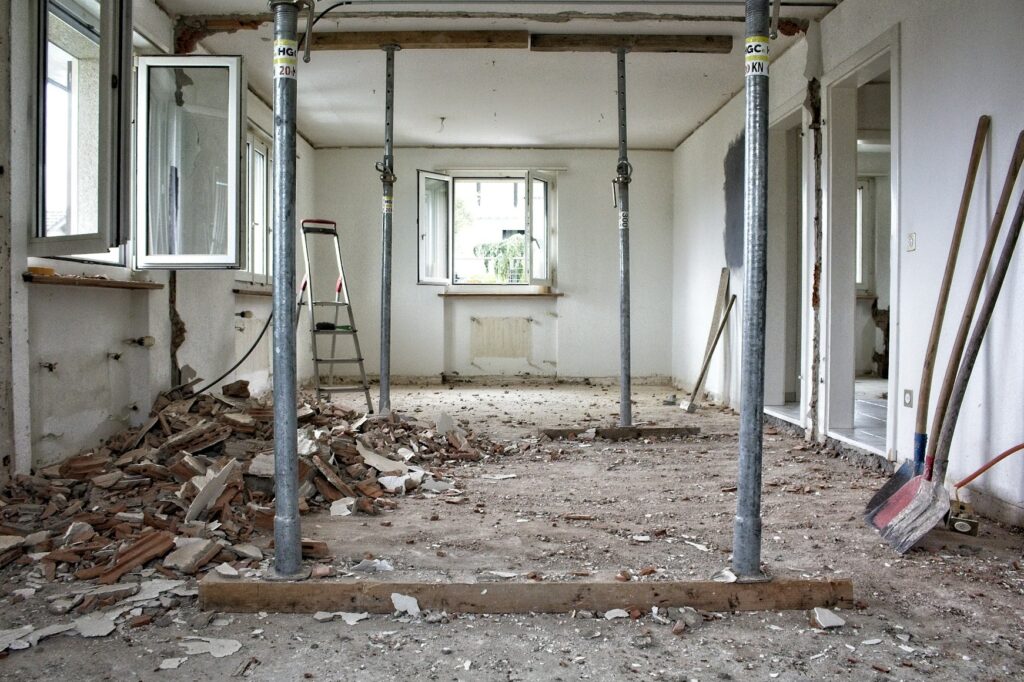 Unfinished room with support poles and construction debris