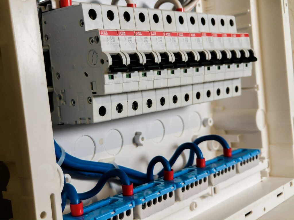 Rows of white circuit breakers in an electrical panel