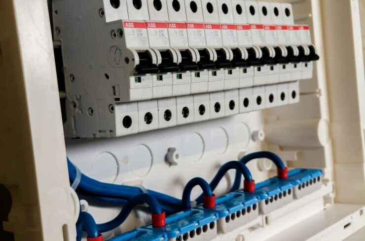 Rows of white circuit breakers in an electrical panel