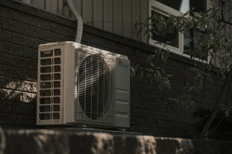 Outdoor air conditioning unit against a brick wall