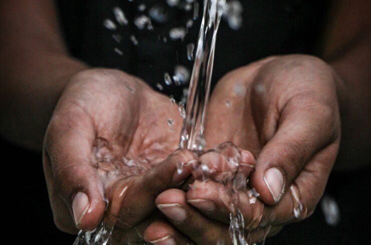 Water pouring over a person’s hands