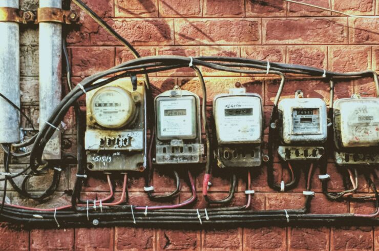 Five electric meters on a wall