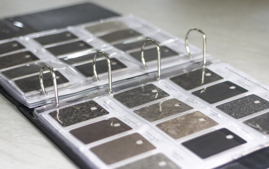 Open binder displaying countertop material samples