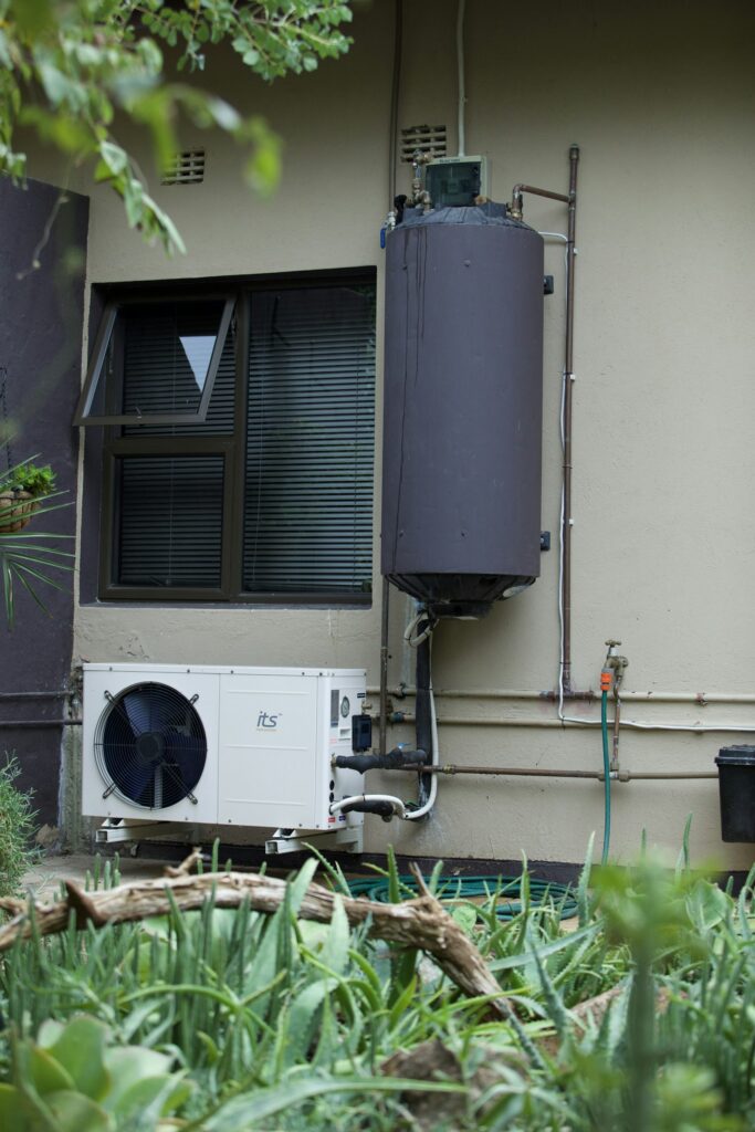 Residential water heater and air conditioner on an exterior wall