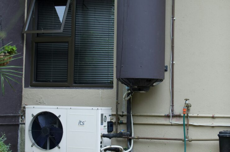 Residential water heater and air conditioner on an exterior wall