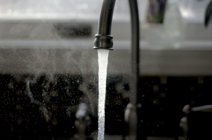 Water running from a kitchen faucet into a sink